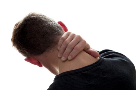 man holding his neck in pain